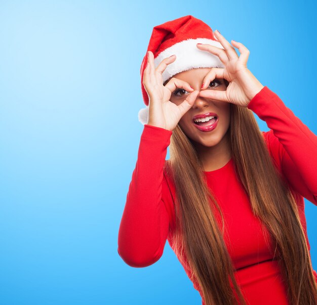 Frau, die Finger Brille in einem blauen Hintergrund