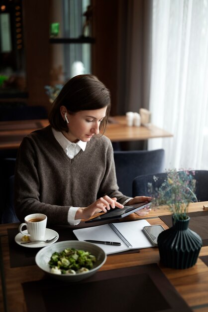 Frau, die mit hohem Winkel der Tablette arbeitet