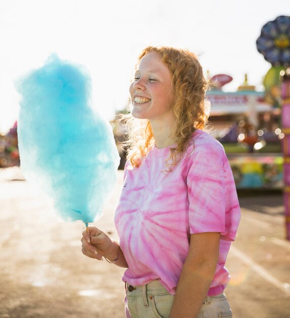 Frau, die mittleren Schuss der Zuckerwatte betrachtet