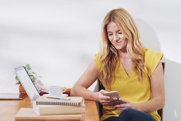 Kostenloses Foto frau, die zeit mit smartphone verbringt