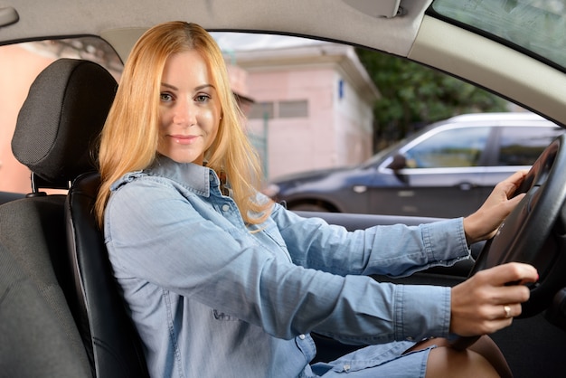 Frau im Auto mit Massage-Sitzkissen