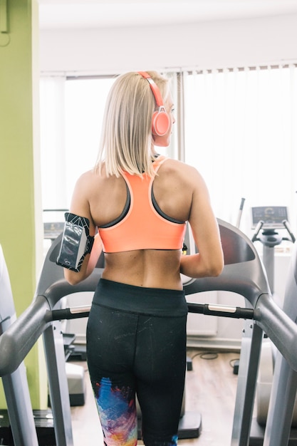 Kostenloses Foto frau in sportkleidung läuft auf dem laufband