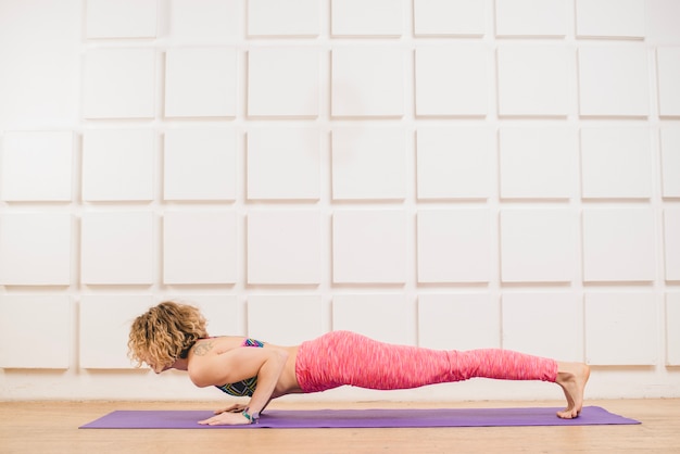 Frau macht Push-ups auf Yogamatte