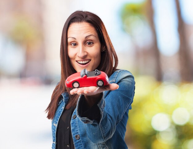 Frau mit einem roten Auto