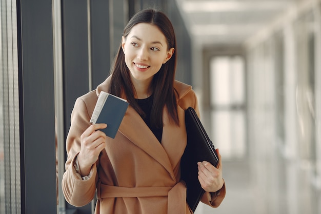 Frau mit Koffer am Flughafen