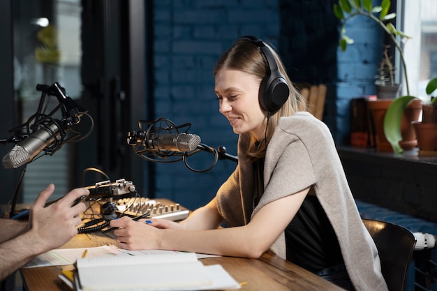 Kostenloses Foto frau mit kopfhörern, die einen podcast laufen lässt