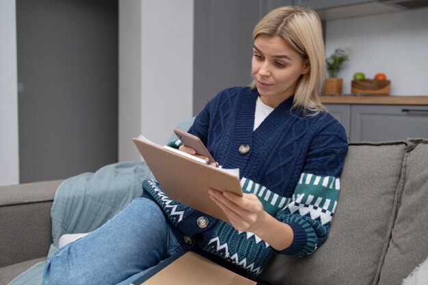 Frau mit mittlerer Aufnahme, die Smartphone hält