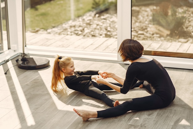 Frau mit Tochter ist in der Gymnastik beschäftigt