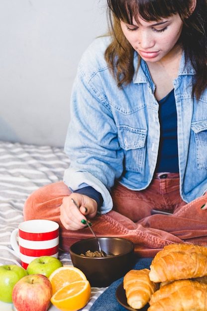 Kostenloses Foto frau sitzt mit frühstück essen