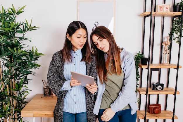 Kostenloses Foto frauen, die tablette im büro verwenden