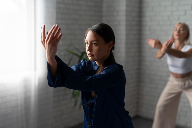 Frauen, die Tai-Chi-Seitenansicht üben