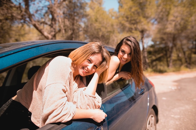 Frauen im Auto, das Kamera betrachtet