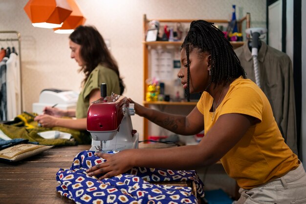 Frauen modifizieren Kleidung im Secondhand-Laden