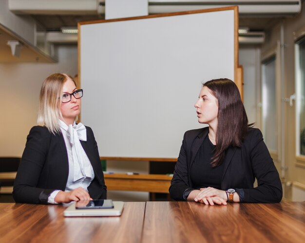 Frauen sitzen am Tisch reden