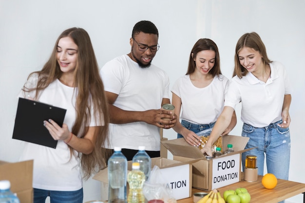 Freiwillige, die Kisten für die Spende mit Lebensmitteln vorbereiten