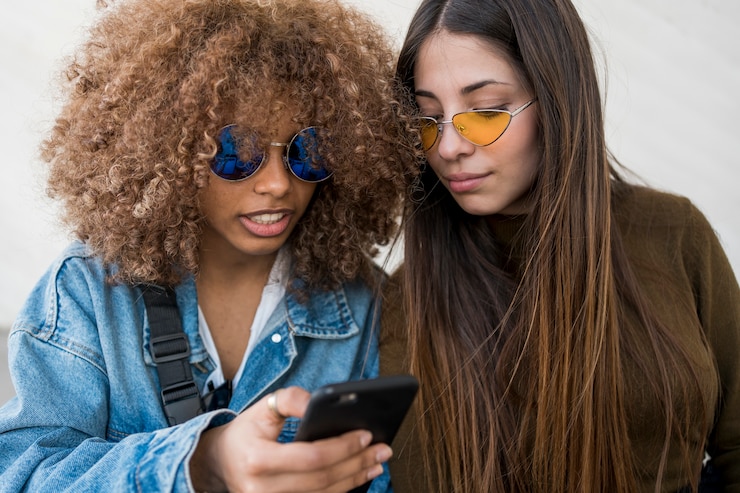 Kostenlose Foto freunde, die auf telefon schauen