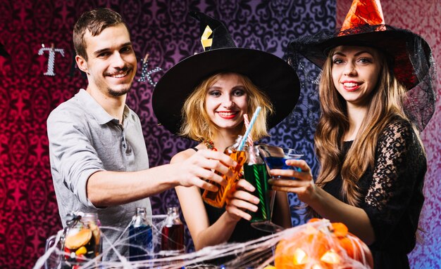 Freunde, die Gläser auf Halloween-Party klingen