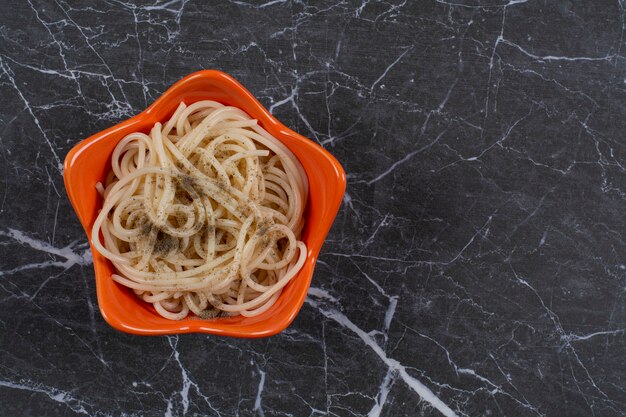 Frische hausgemachte Spaghetti mit Gewürzen in der Orangenschale.