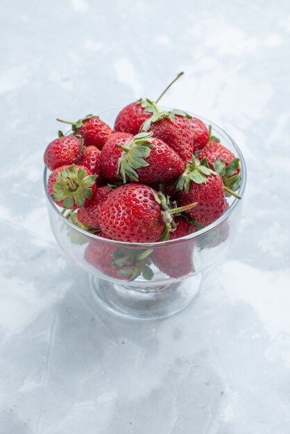 frische rote Erdbeeren milde Sommerbeeren innerhalb der Glasplatte auf weißem Schreibtisch