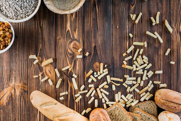 Frisches Brotlaib mit Bestandteilen auf Holztisch