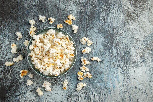 Frisches Popcorn der Draufsicht auf leichtem Schreibtisch