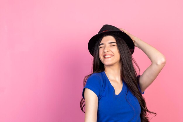 Fröhliche junge Dame mit Hut und lächelnd Foto in hoher Qualität