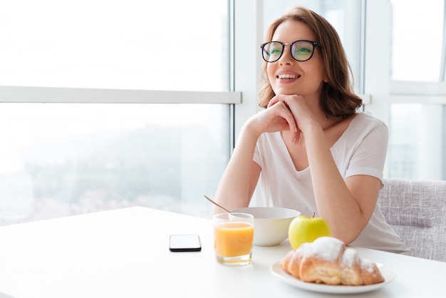 Fröhliche junge Frau, die Cornflakes isst