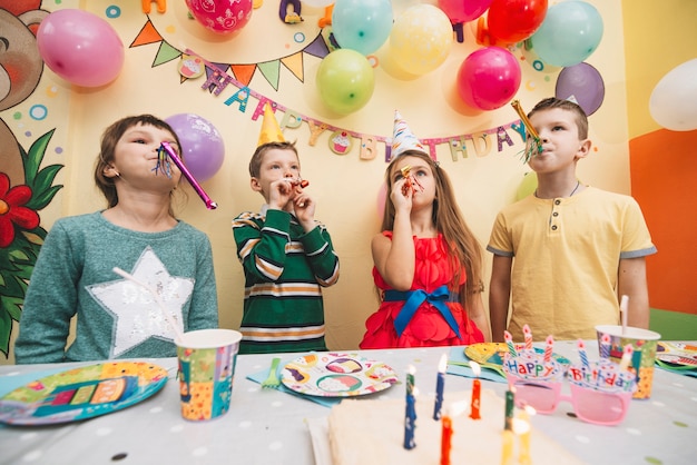 Fröhliche Kinder mit Partyhörnern