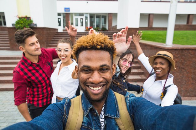 Fröhliche Studenten, die zusammen fotografieren