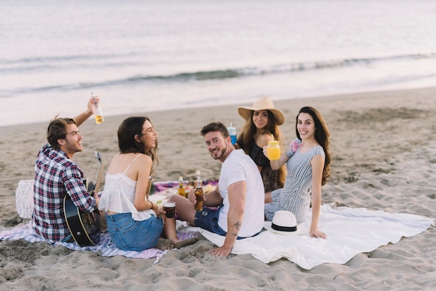 Fünf Freunde sitzen am Strand