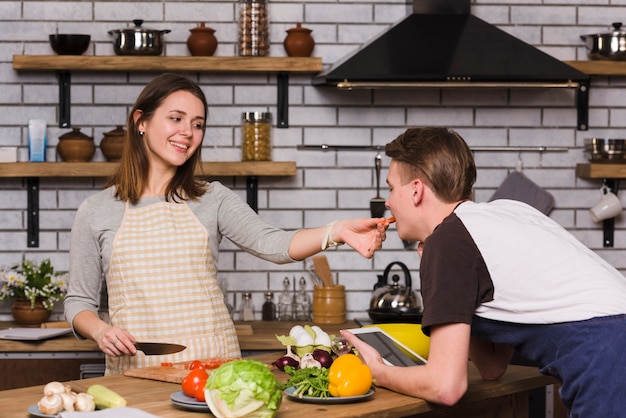 Fütterungsfreund der jungen Frau mit geschnittener Tomate