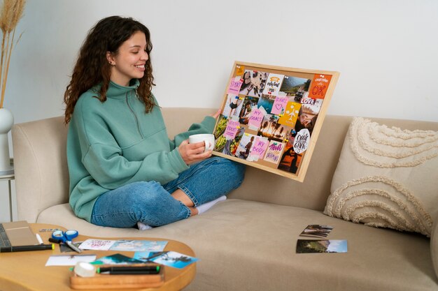 Full-Shot-Frau, die ein inspirierendes Vision Board erstellt