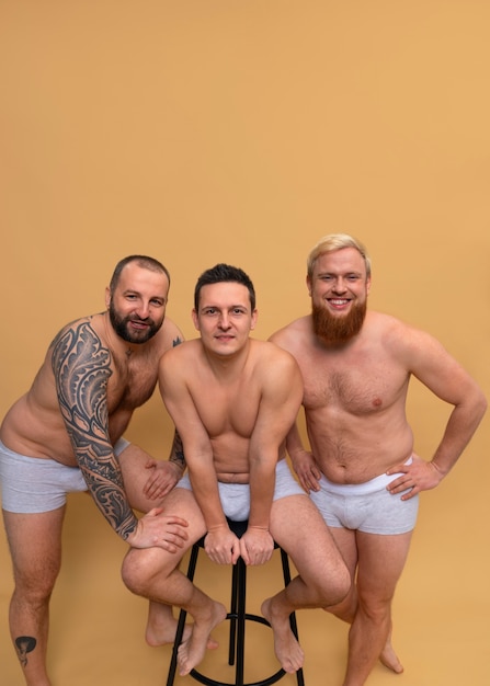 Kostenloses Foto full-shot-männer posieren zusammen im studio