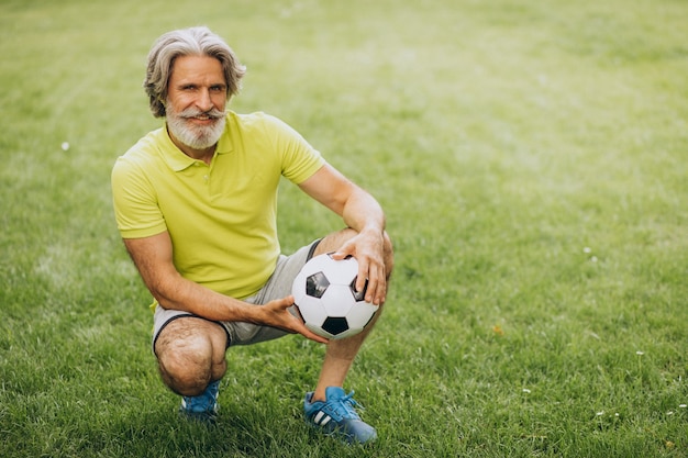 Fußballspieler mittleren Alters mit Fußball