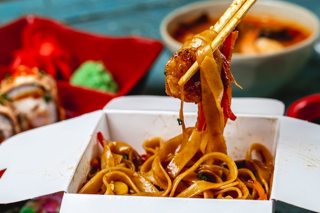 Kostenloses Foto gebratene nudeln in der seitenansicht mit gegrillter garnelensauce, frühlingszwiebeln und paprika