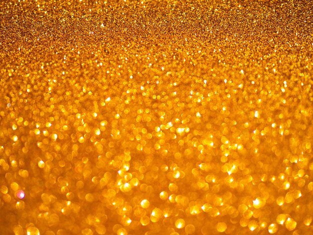 Gelber glitzernder Tapetenhintergrund