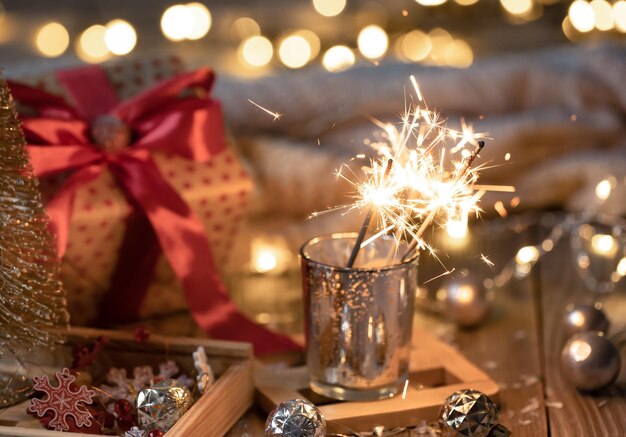 Gemütlicher Weihnachtshintergrund mit leuchtenden Wunderkerzen und Dekordetails