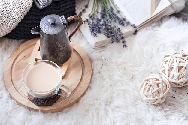 Gemütliches Stillleben mit Wasserkocher und einer Tasse heißem Getränk