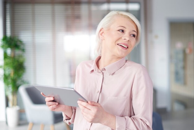 Geschäftsfrau mit digitaler Tablette lachend