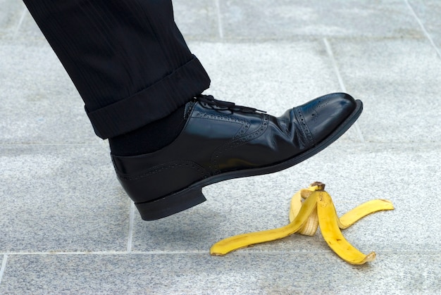Kostenloses Foto geschäftsmann treten auf bananenschale