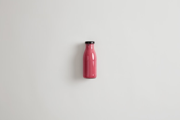 Gesunde Ernährung, sauberes Essen und vegetarisches Konzept. Gemischter rosa Erdbeer-Johannisbeer-Rote-Bete-Smoothie in Glasflasche. Diätgetränk mit potenziellen gesundheitlichen Vorteilen. Quelle oder Protein.