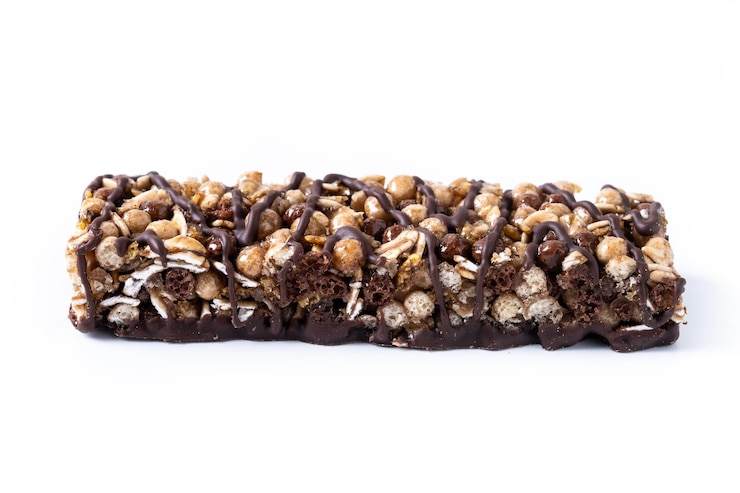 Kostenlose Foto gesunde muesli-riegel mit nüssen und samen auf weißem hintergrund