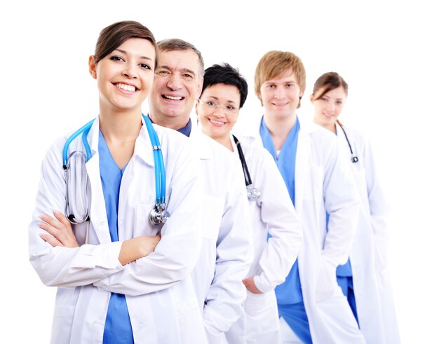 Glücklich lachende Ärztinnen in Krankenhauskleidern in Reihe
