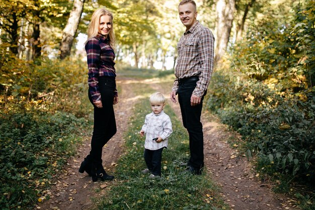 glückliche Familie, die im Herbstpark spielt und lacht