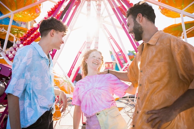 Kostenloses Foto glückliche freunde am funfair im sonnenlicht