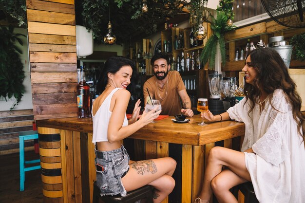 Glückliche Freunde sitzen am Tisch