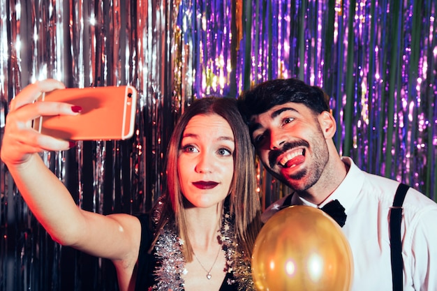 Glückliches Paar, das selfie auf Party der neuen Jahre nimmt