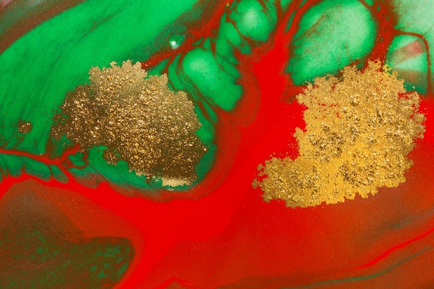 Goldflecken auf rotem und grünem farbhintergrund des flusses abstrakter druck Premium Fotos