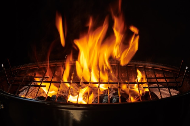 Grill Hintergrund. Barbecue Fire Grill Nahaufnahme, isoliert auf schwarzem Hintergrund