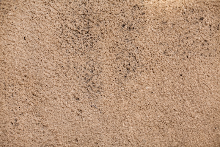 Kostenlose Foto grobe wandstruktur mit schwarzen flecken